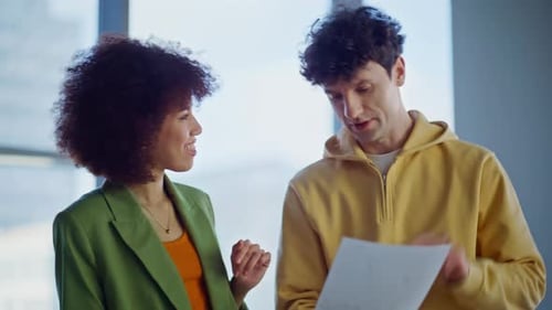 Smiling Colleagues Discussing Papers in Light Office Closeup Happy Partners