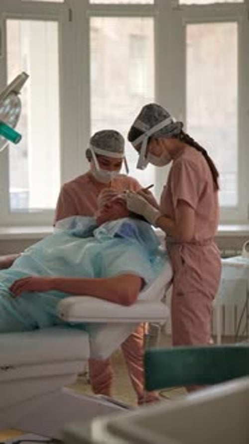 Healthcare Providers Examine Patient in Hospital Setting