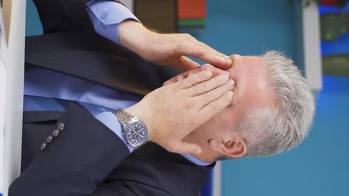 Man in Suit Expressing Frustration at Work