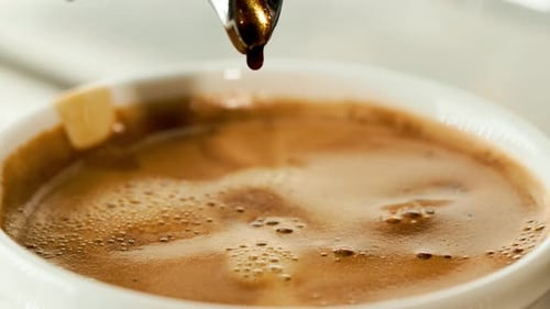 Fresh Espresso Being Poured Into White Cup