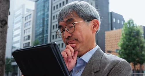 Mature business man, thinking and tablet in city for planning, brainstorming