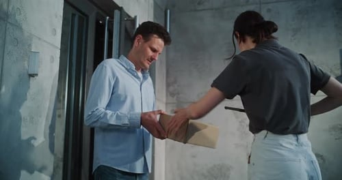 Delivery Woman Handing Box to Man at Building