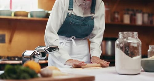 Rolling, dough and hands with food, kitchen and meal prep with pasta maker, culinary and restaurant