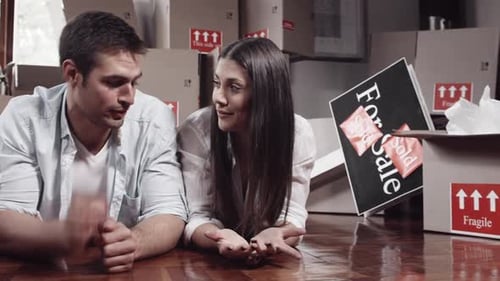 Couple Lying on Floor with Moving Boxes