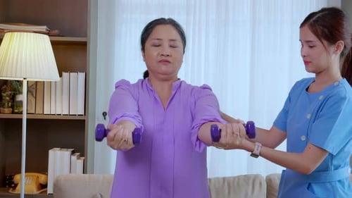 Woman Exercising with Healthcare Assistant at Home