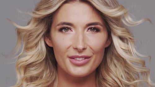 Studio Portrait of Young and Beautiful Blond Woman Over Grey Background Skin Care and Wellness