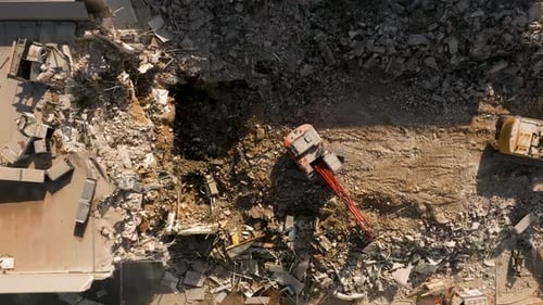 Excavator demolishing a residential building, Aerial view