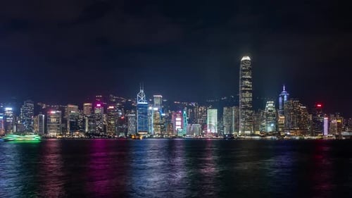 Nighttime Hong Kong City Skyline with Illuminated Skyscrapers and Vibrant Reflections on Water