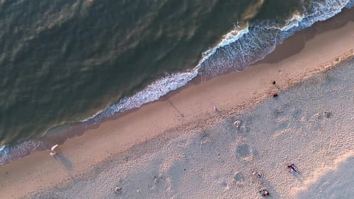 Beautiful flight in summer over the beach in Katwijk aan Zee. People are resting near the sea.
