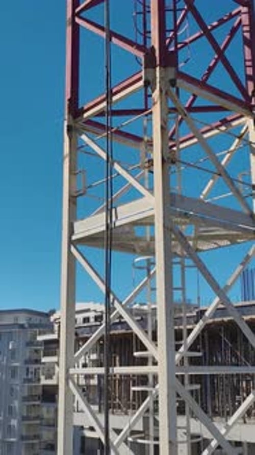 Vertical Video Construction Workers Installing Framework for Concrete Floors With Scaffolding and