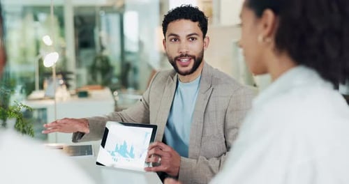 Man, tablet and charts at office meeting with team, smile or discussion for stats at investment