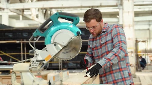 Building Contractor Worker Using Hand Held Worm Drive Circular Saw to Cut Boards on a New Home