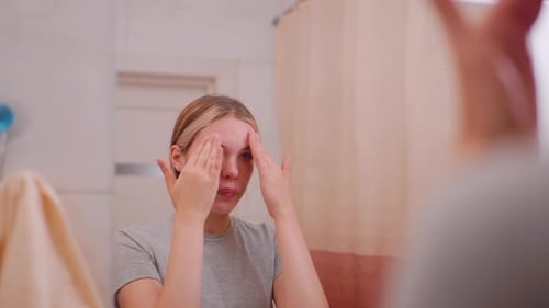 Teenager Applying Lotion on Face for Skincare Routine