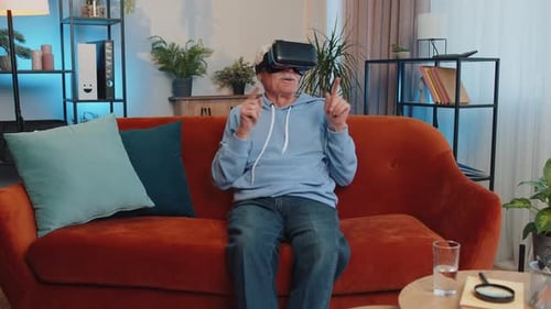Senior Man Using Virtual Reality Headset at Home