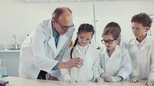 Children Learn Science with Teacher in Bright Laboratory