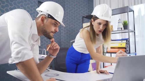 Engineers hold meeting on drawing project.