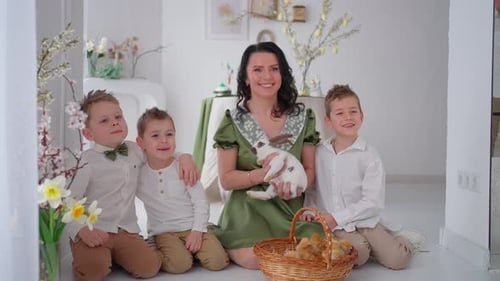 Mother and Sons with Rabbit in Bright Home