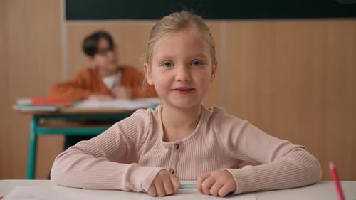 Portrait Happy Pretty Girl Back to School Class Lesson Posing at Table Looking at Camera Smiling