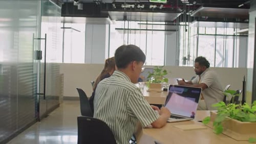 Young Adults Collaborating in Modern Workplace