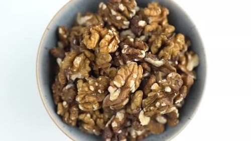 Bowl Of Walnuts Shot From Above. Spinning Nuts. Protein Plant Based Raw Vegan Food. Health And Veget