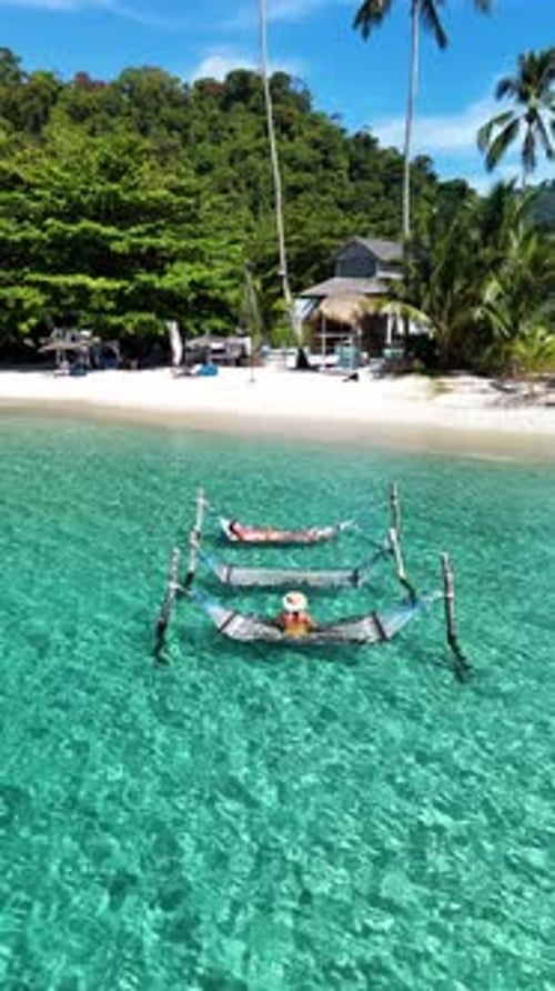 Relaxing on Idyllic Hammocks in Crystal Clear Waters of Tropical Koh Kood Thailand Paradise