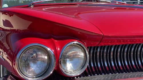 Vintage Red Car Headlights and Grill Close Up