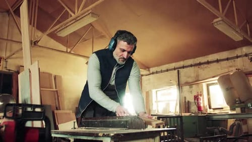 A Man Worker in the Carpentry Workshop, Working with Wood