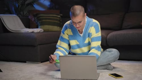 Happy Woman Buying and Paying with Credit Card on Online Shop Using Laptop at Home at Night