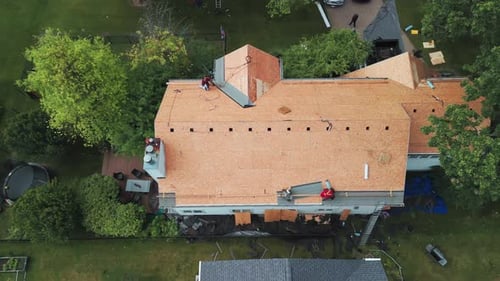 Top Down View of Roofers Installing a New Roof on an Residential Building Top Down Shot