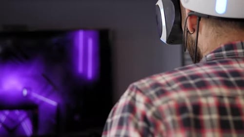 Man Immersed in Virtual Reality Gaming at Home