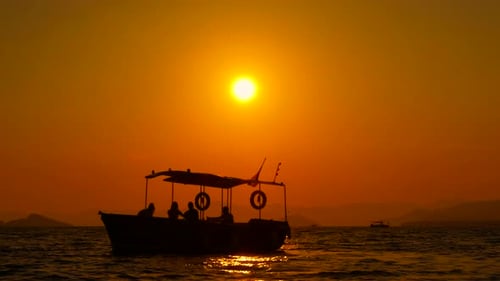 Boat Sailing on the Water at Sunset