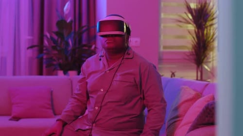 Man using VR headset in stylishly lit home