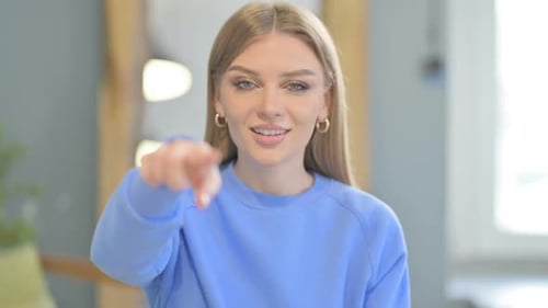 Smiling Woman Points at the Camera