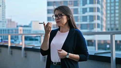 Woman Using Smartphone on an Urban Rooftop