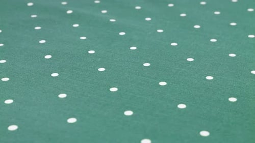 Top view of the queen blue with white polka dots cotton fabric rotated on the display case.