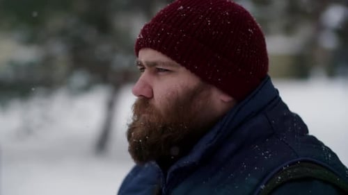 Mid Shot Serious and Bearded Man with Blurred Snow City Streets Slo Mo Male Serious Scandinavian