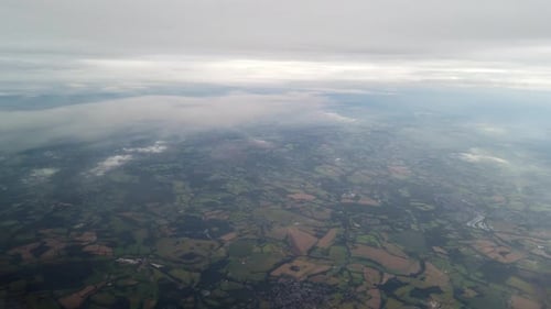High altitude british landscape overcast day view from airplane window