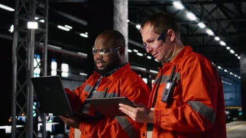 Employees Team Guide Assembly and Fabrication Duties in a Warehouse Facility