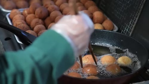A woman making sata andagi