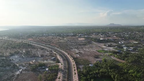 Aerial View of Highway Through Urban and Natural Landscape