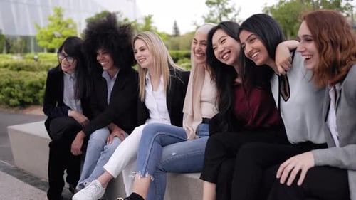 Happy business women team having fun meeting outside office buildings