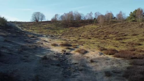 Aerial drone shot of nature national park with sun shining above the hill.