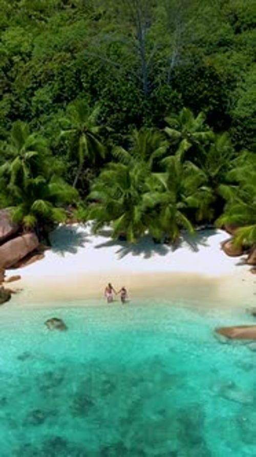 Couple Walking on the Beach of Anse Lazio Beach Praslin Island Seychellesbeach of Anse Petite