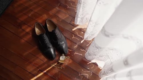 Close-up of wedding accessories on wooden floor in a vintage room setting