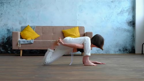 Woman Practicing Yoga Stretches in Modern Home