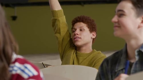 Zoomer Raising Hand to Ask Question during Lecture with Peers in University