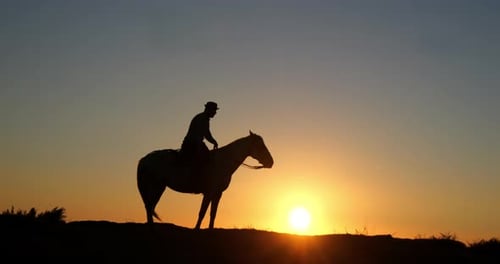 Horse and Rider Silhouette at Dramatic Sunrise