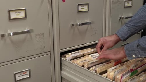 Office Worker Opening a File Cabinet.