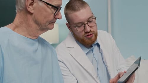 Doctor Explains Diagnosis to Patient on Tablet in Hospital