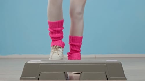 Woman Doing Step Aerobics in 1980s Style